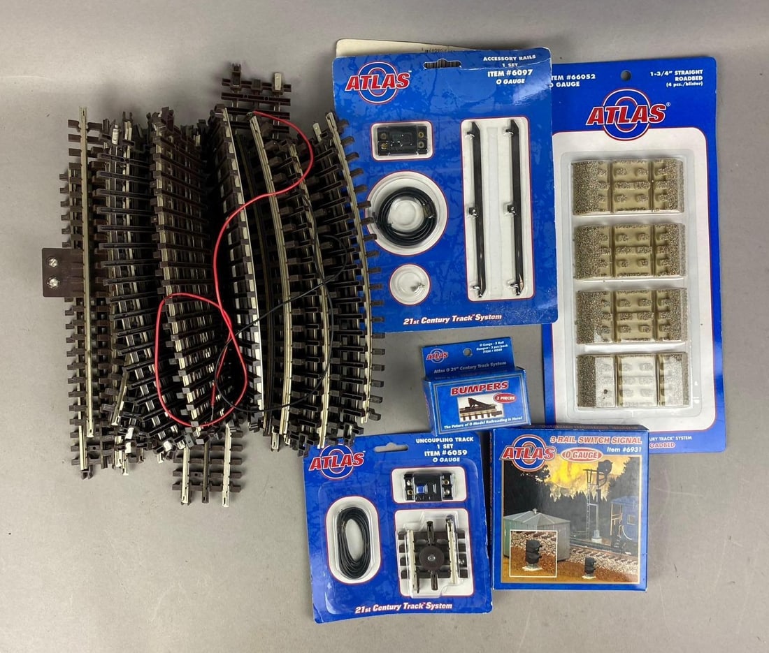 Group of Assorted Atlas O Gauge Tracks and More: Includes Uncoupling track, connectors, and more. Largest measures 9 inches long.