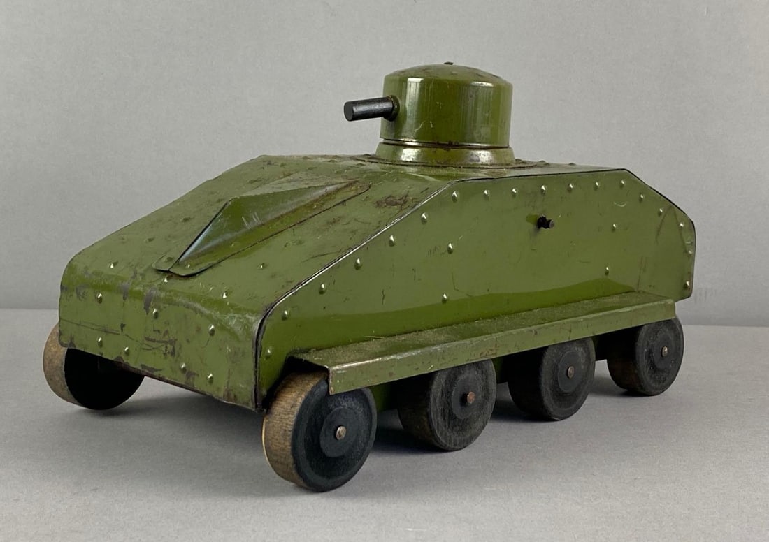 Vintage Structo Pressed Steel Tank Toy: Noise Crank in working condition, paint wear shown, measures 6 1/2 inches H x 7 inches W x 12 inches D