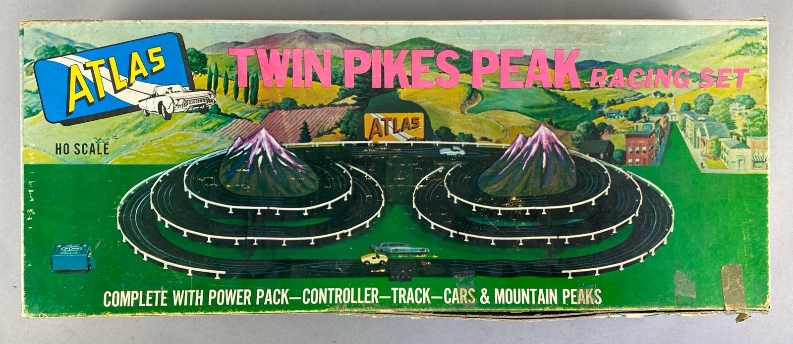 1960s Atlas HO Scale Twin Pikes Peak Slot Car Racing Set: Untested in original box, missing cars, mountains and more. shelf wear shown, box measures 10 inches H x 25 1/2 inches W x 3 1/2 inches D