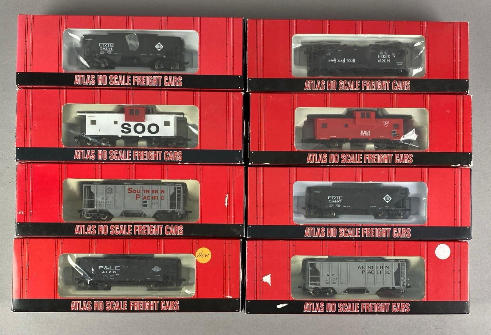 Group of Assorted Atlas HO Scale Train Cars: In original boxes, includes SP hopper, WO hopper, D and H Caboose and more, each measures 11 inches W