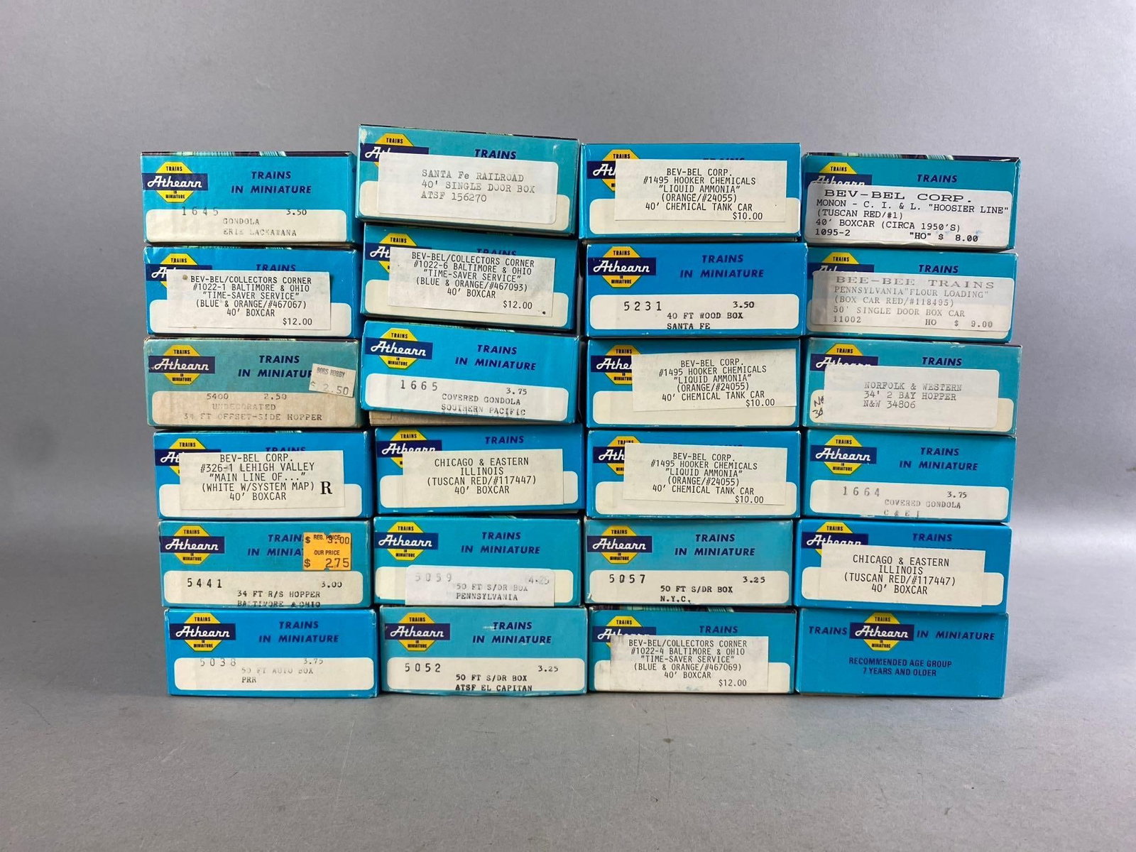 Group of 10+ Athearn HO Scale train Cars: Includes Hopper, Boxcar, and more. Largest measures L 8 x W 4 inches.
