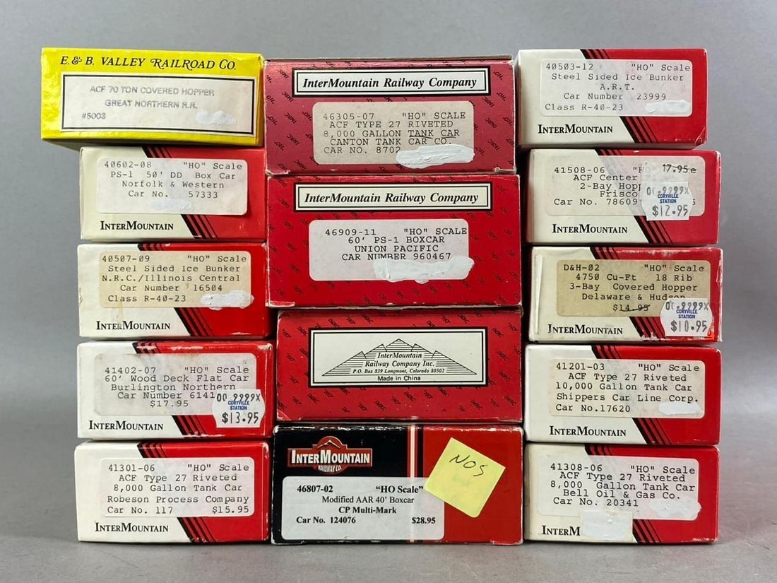 Group of 10+ InterMountion Railway Company HO Scale Train Cars and More: Includes Hopper, Tank Car, and more. Largest measures L 8 x W 4 inches.