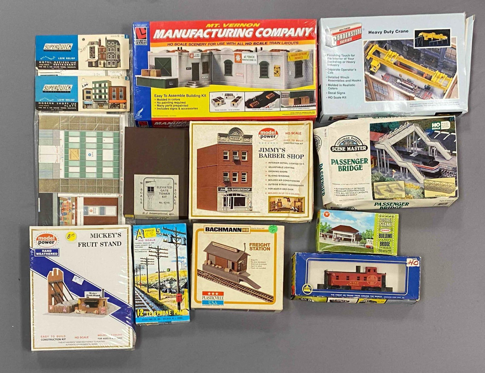 Group of Assorted HO Scale Model Train Building Plastic Model Kits and More: some sealed, includes telephone poles, freight station, passenger bridge and more