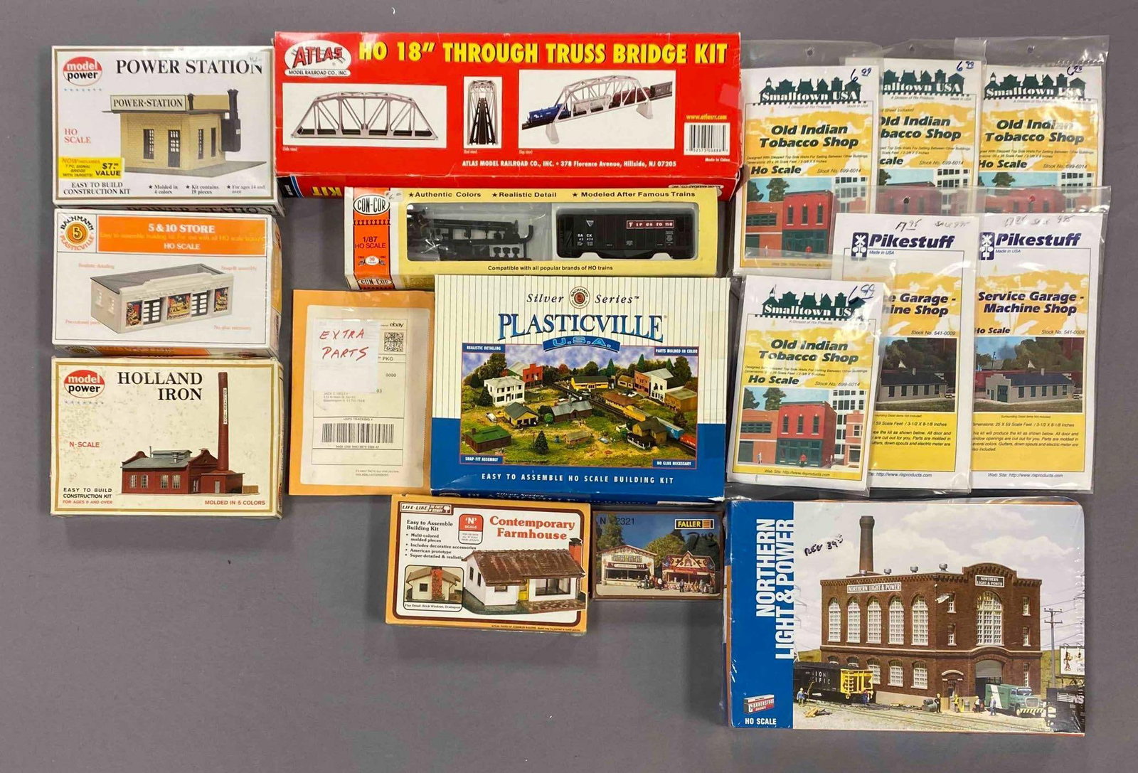 Group of Assorted HO Scale Model Train Building Plastic Model Kits and More: most sealed, includes contemporary farmhouse, through truss bridge kit, holland iron and more, largest measures 9 inches H x 14 inches W