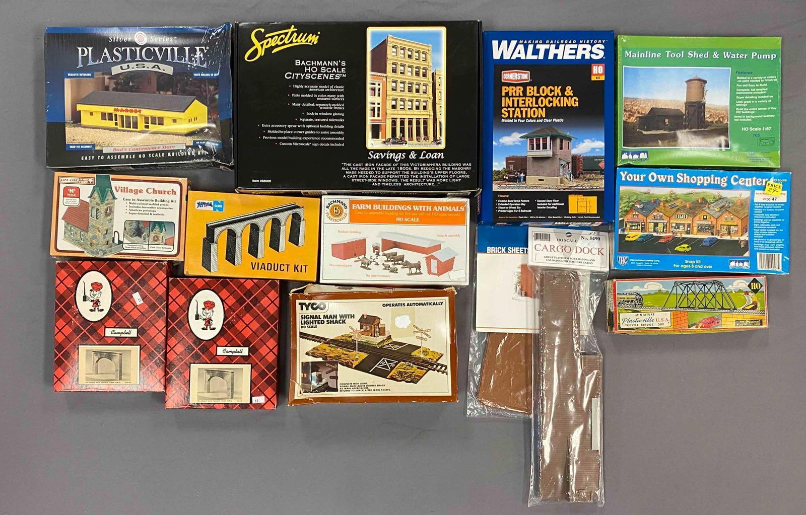 Group of Assorted HO Scale Model Train Building Plastic Model Kits and More: some sealed, includes cargo dock, concrete portals, trestle bridge. Prr block and interlocking station, largest measured 10 inches H x 15 inches W