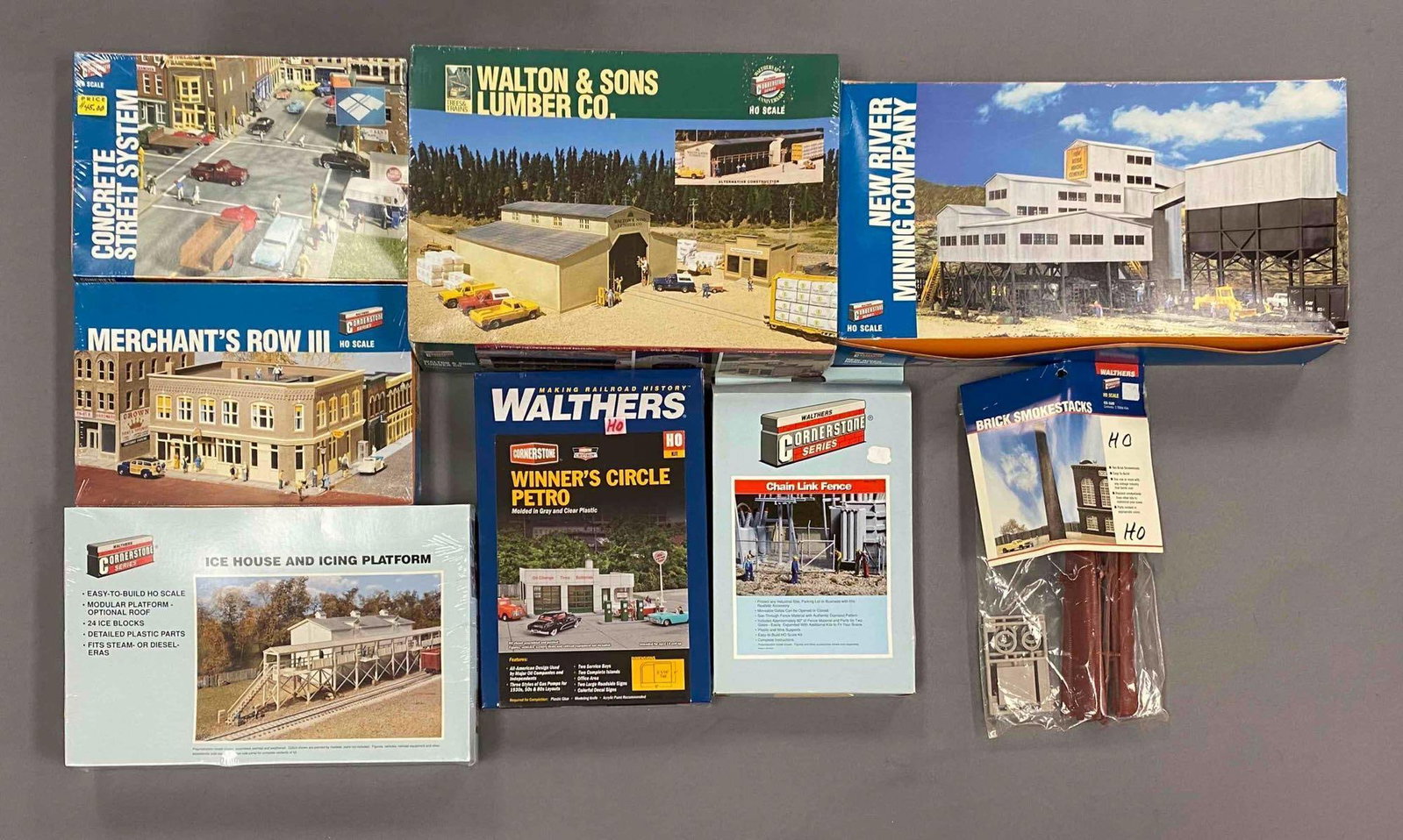 Group of 8 Walthers Cornerstone HO Scale Model Train Building Plastic Model Kits and More: Most sealed, inclufes ice house and icing platform, chain link fence, winner circle petro and more, largest measures 10 inches H x 15 inches W