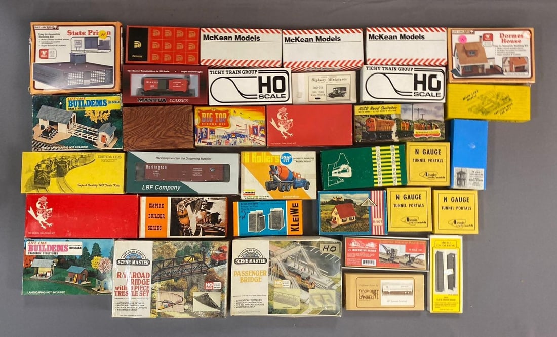 Group of 10+ HO Scale Model Building and More: Includes house, car, and more. Largest measures L 10 x W 7 inches.