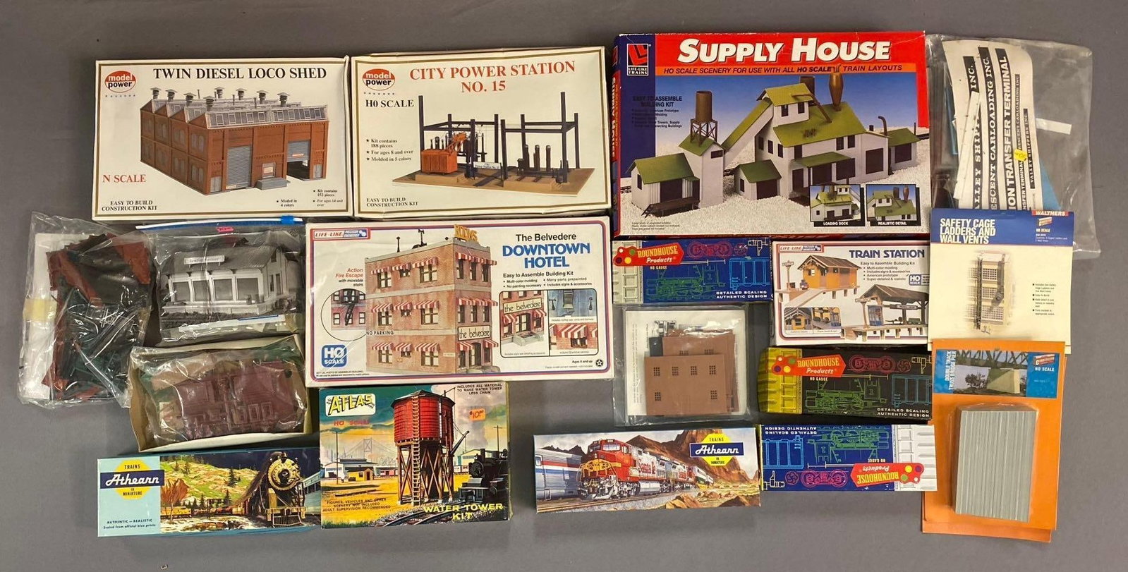 Group of 10+ Model Power HO Scale Buildings and More: Includes hotel, station, and more. Largest measures L 12 x W 6 inches.