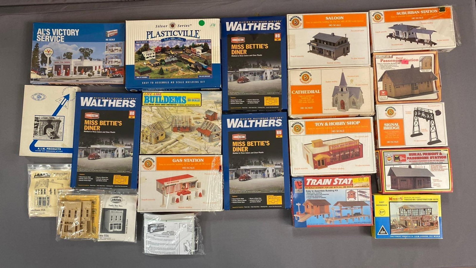 Group of 10+ Walthers Cornerstone HO Scale Buildings and More: Includes diner, hobby shop, and more. Largest measures L 12 x W 8 inches.
