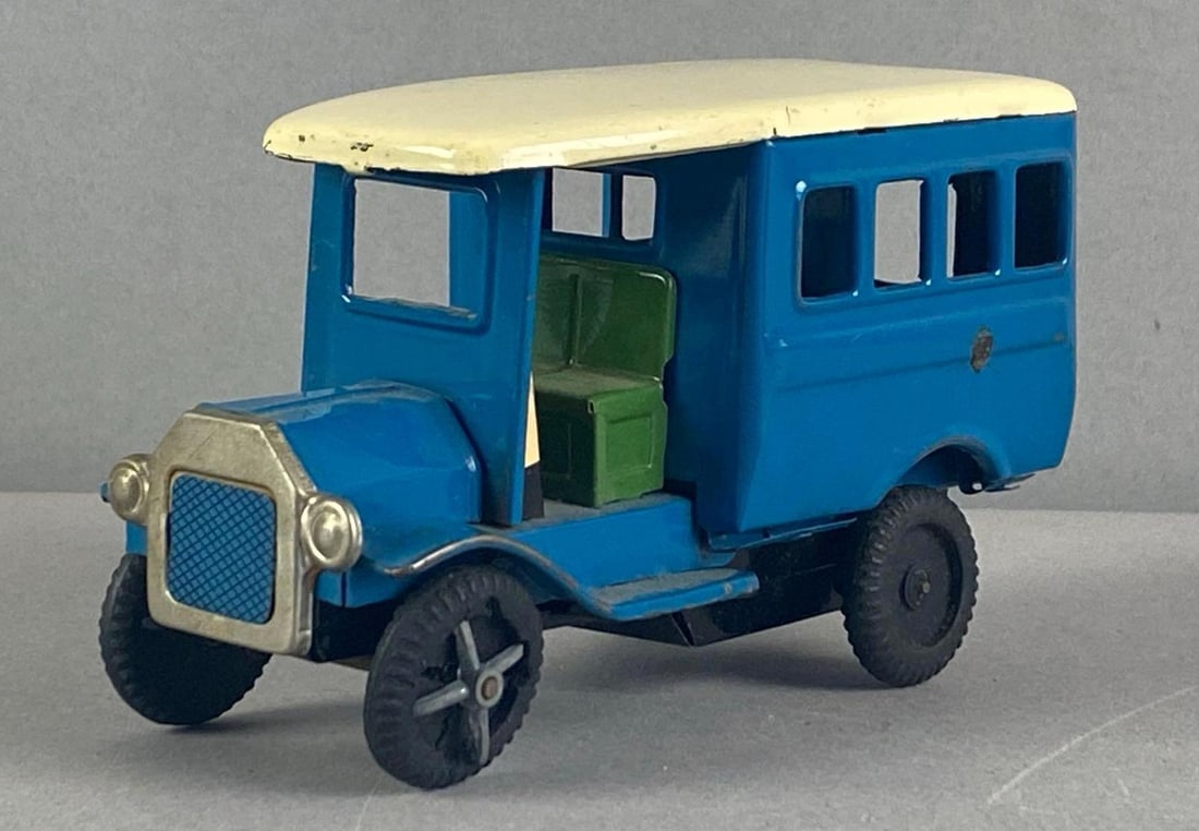 Vintage Japanese Tin-Litho Friction Toy Bus: In working condition, deteriorating wheels, measures 2 3/4 inches H x 2 1/4 inches W x 4 1/2 inches D