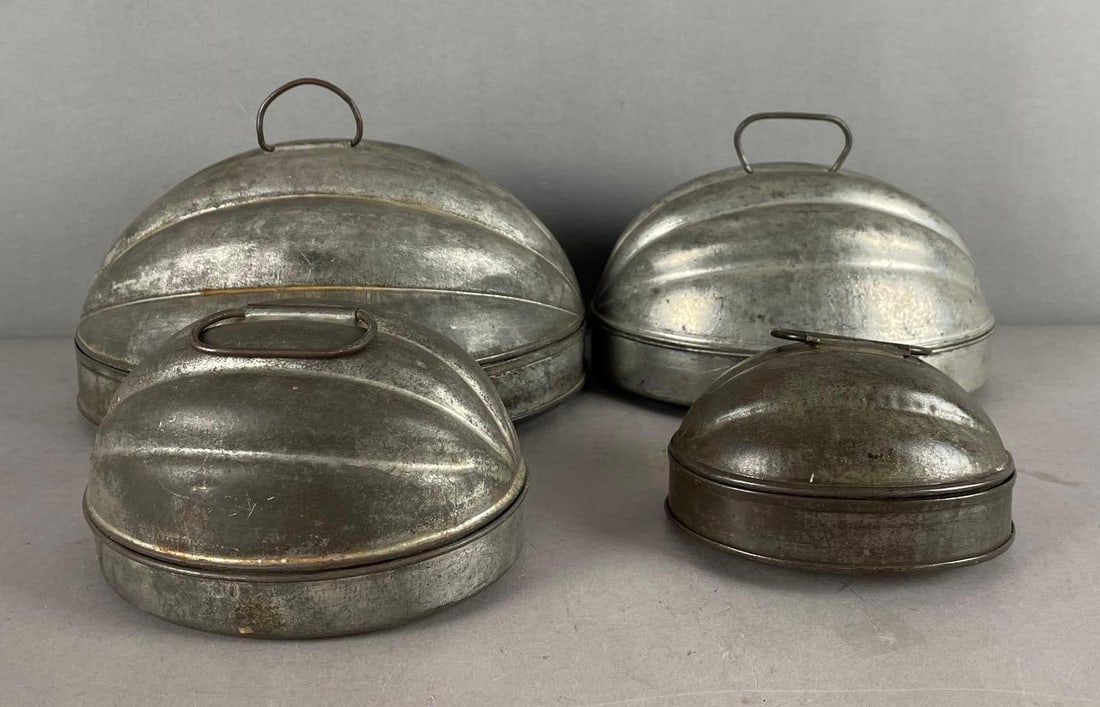 Set of 4 Antique Nesting Metal Pudding Molds: Largest measures 5 inches x 10 1/4 inches x 8 inches