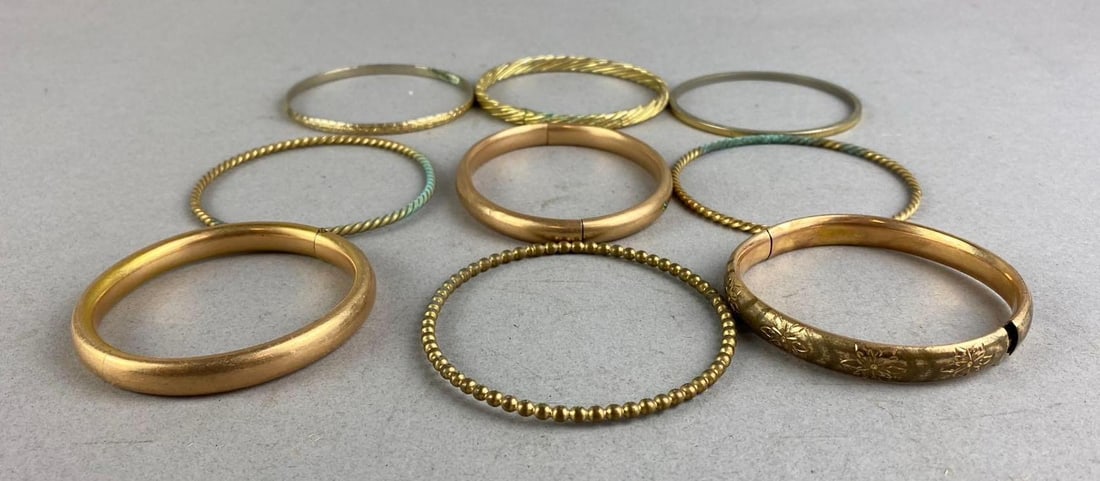 Group of 9 Costume Jewelry Bracelets: Mostly brass. Largest measures 2 1/2 inches in diameter.