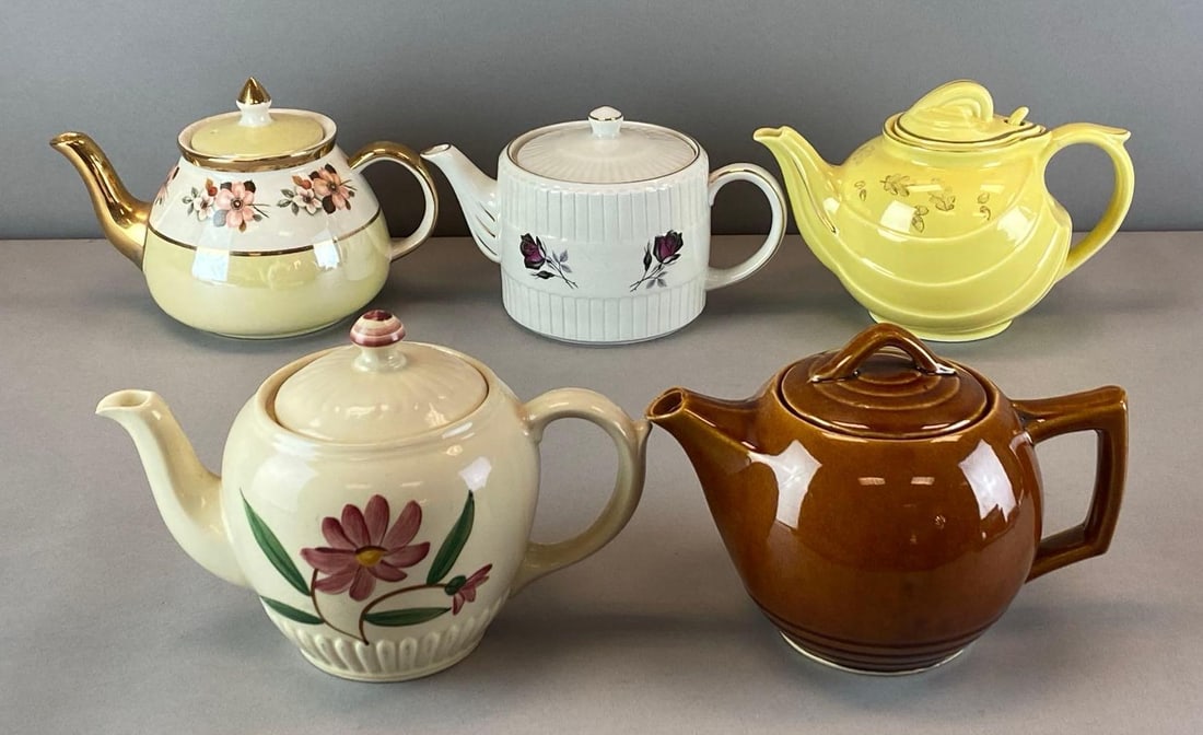 Group of 6 Porcelain Teapots: most feature floral motif, largest measures 6 inches H x 9 inches W x 6 1/2 inches D