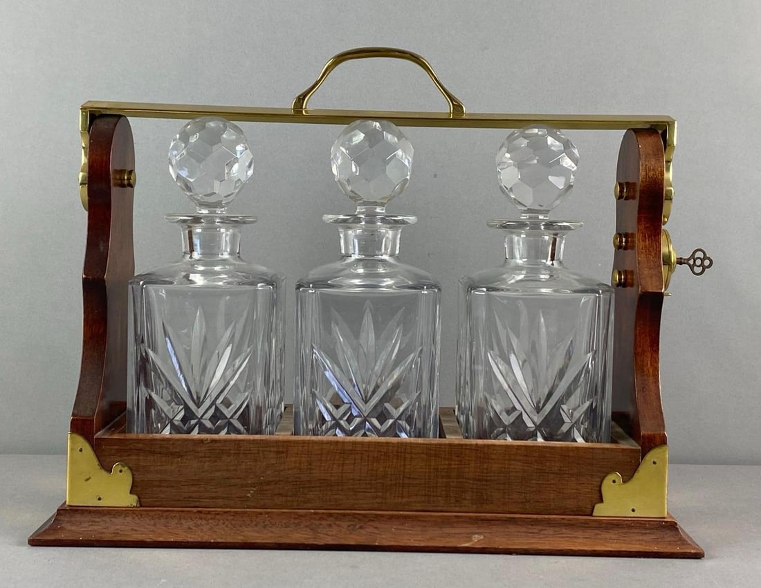 Vintage 3 Crystal Decanter Tantalus: includes original key, features wood and brass frame, faceted stoppers, measures 13 inches H x 16 1/4 inches W x 7 inches D
