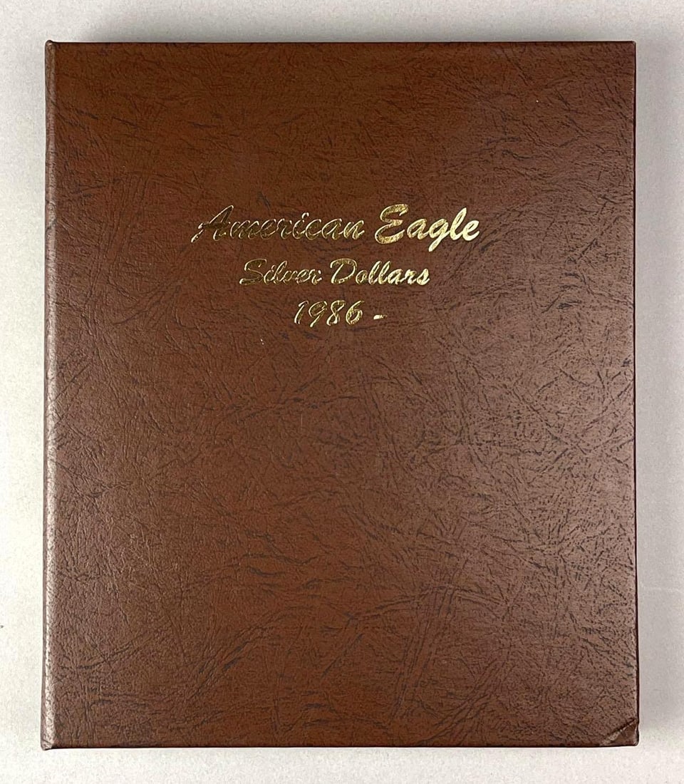 Group of 36 US $1 American Silver Eagle 1 oz Fine Silver Coins in a Dansco Album: Years 1986-2021.