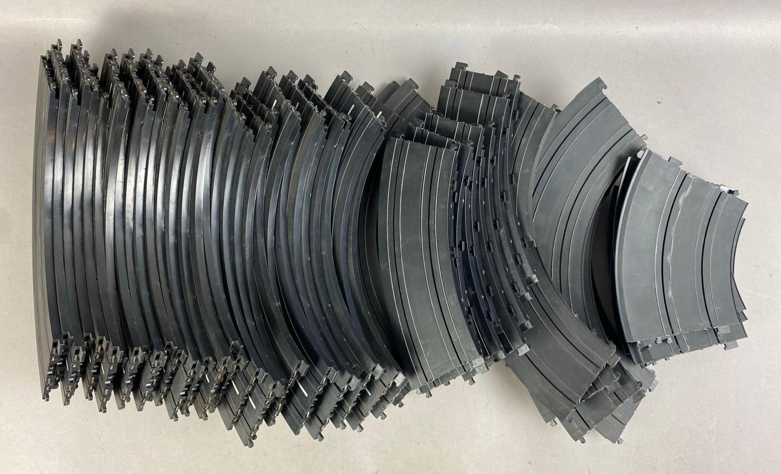 Group of 50 Vintage 1970s Tyco Speedways Slot Car Curve Tracks: Untested. Largest measures 9 inches in length.