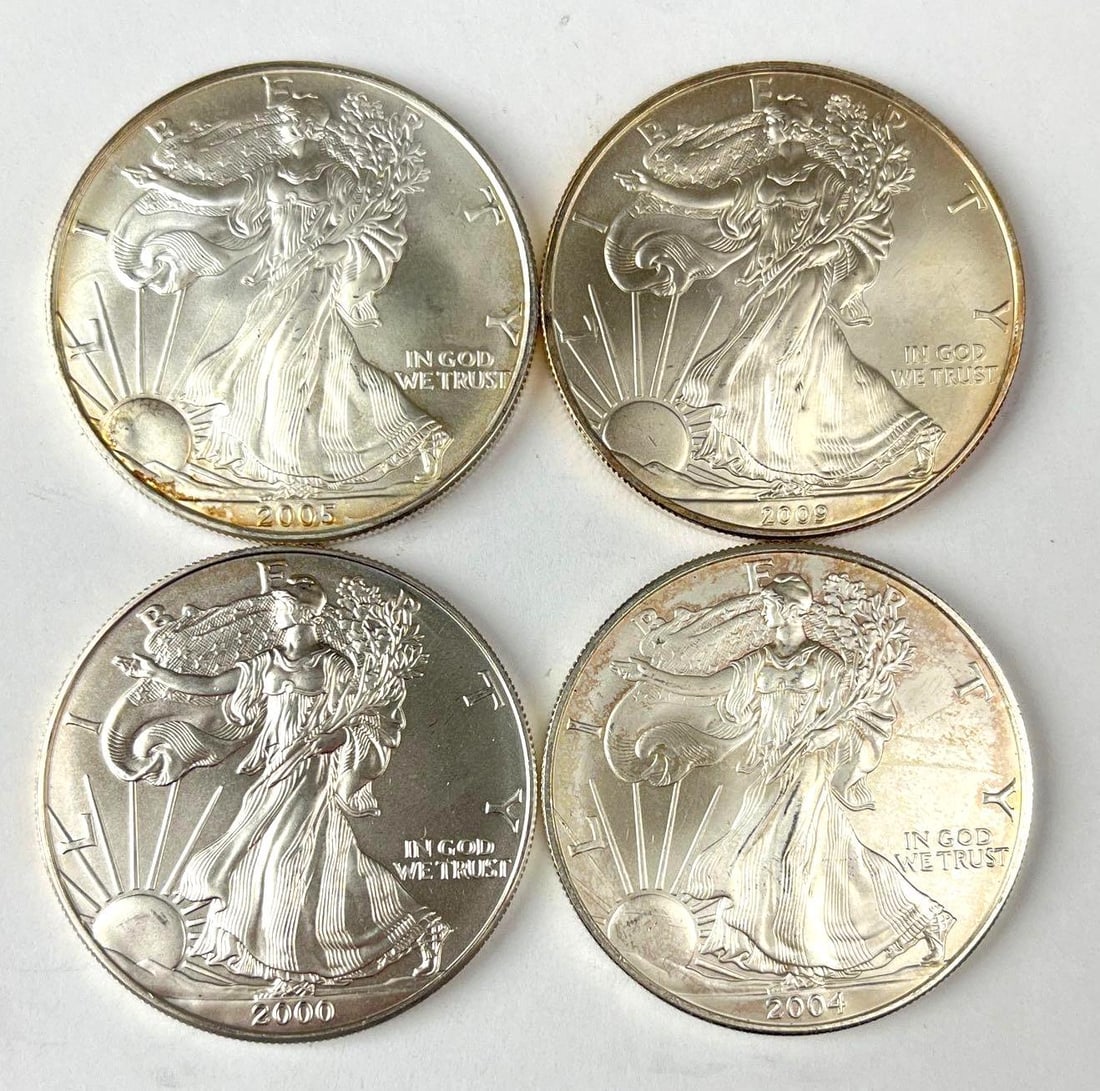 Group of 4 US $1 American Silver Eagle 1 oz Fine Silver Coins: Includes years 2004, 2000, 2009 and 2005.