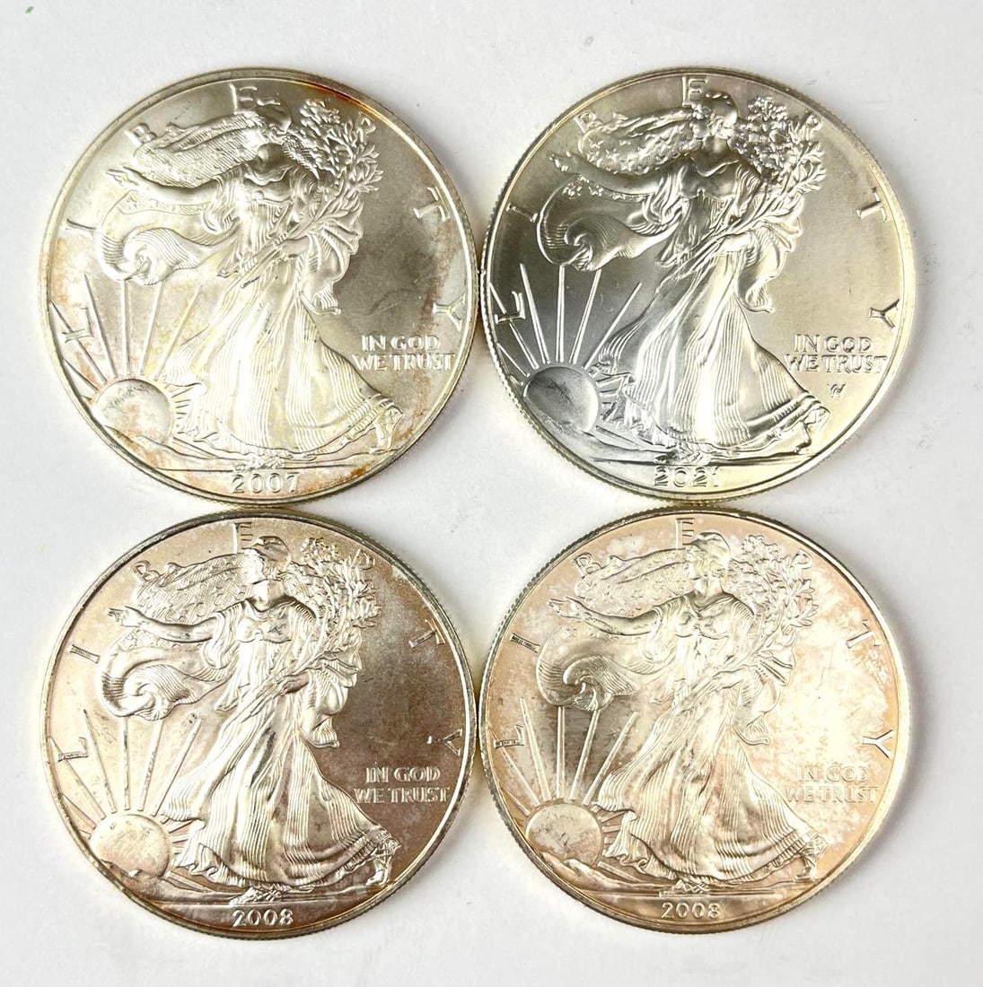 Group of 4 US $1 American Silver Eagle 1 oz Fine Silver Coins: Includes years 2007, 2021 and 2 2008
