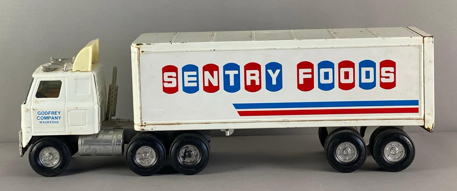 ERTL White Sentry Foods Pressed Steel Tractor Trailer: Some spots of rust, Measures 22 1/4 inches L