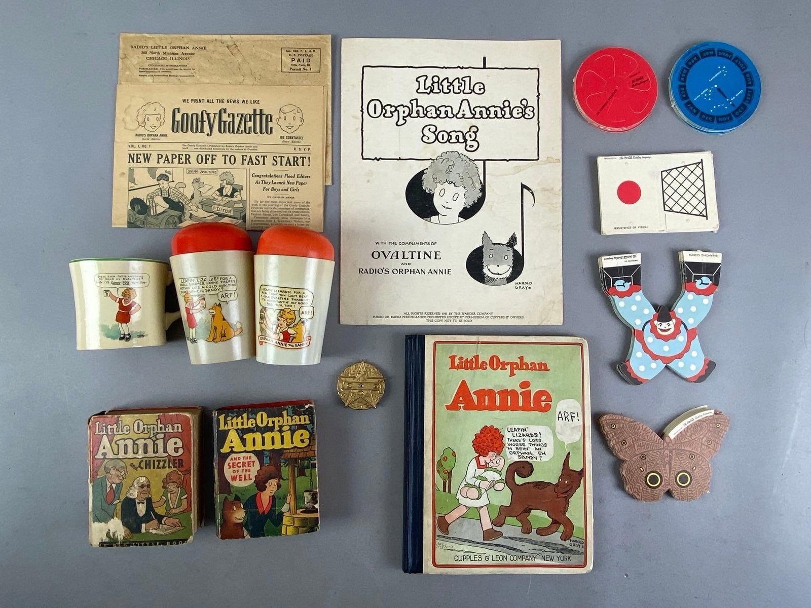 Group of Vintage Little Orphan Annie Ephemera and More: Includes Song Book, cups, Coca-Cola Paper Advertising and more, largest measures 11 1/2 inches H x 9 inches W