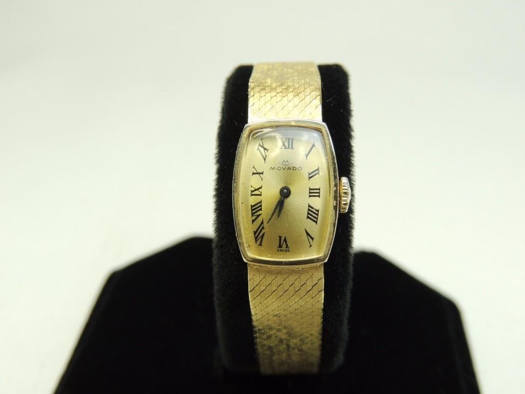 14K Gold Movado Lds. Watch: 23.7 Grams 14K Gold Watch and Band has Fold Over Clasp with Safety Chain (Mechanical Movement)
