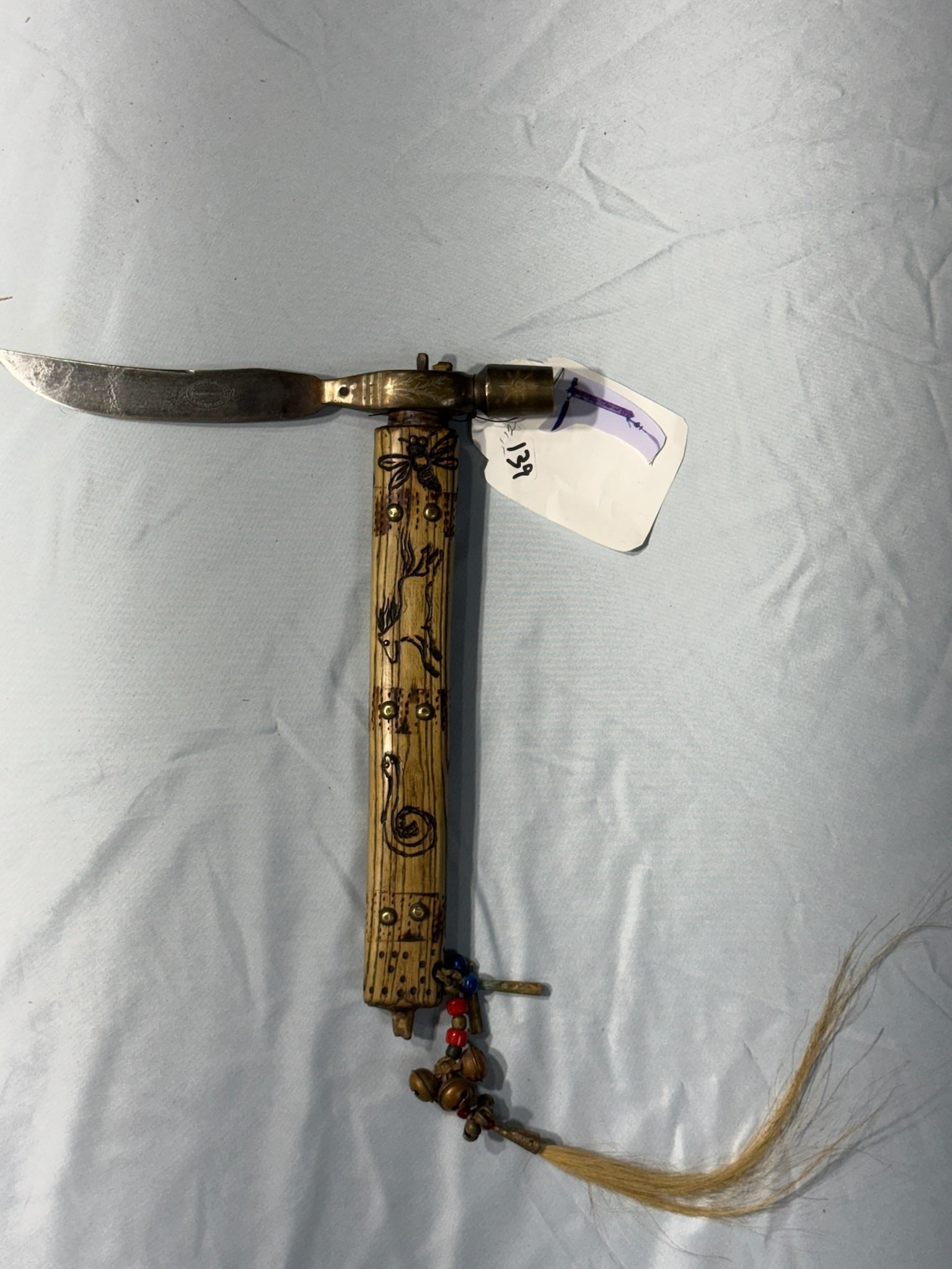 Pipe Tomahawk with carved blade: 11 in. Pipe Tomahawk with carved blade - bells and tinklers - United States Cutlery Blade.