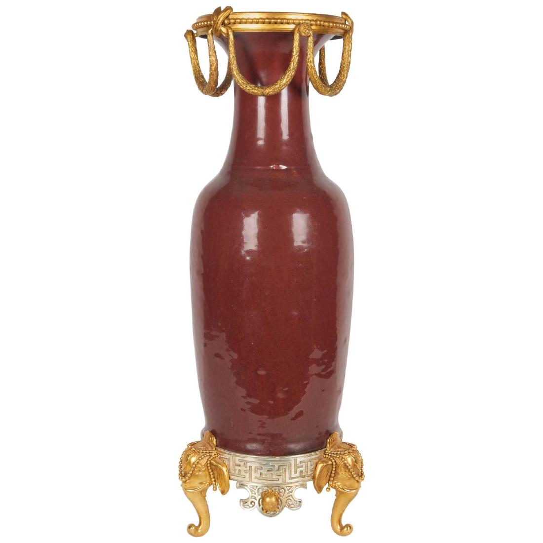Japonisme Ormolu/Silvered Bronze Chinese Porcelain Vase: French Japonisme Ormolu-Mounted and Silvered Bronze Chinese Porcelain Ox Blood Red Vase. Late 19th century. With bronze elephant support heads. DIMENSIONS: 28 in.Hx11 in.Wx8 in.D (71 cmHx28 cmWx20 cmD