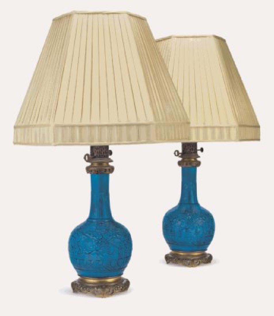 A PAIR OF ORMOLU-MOUNTED "PERSIAN-BLUE" VASES/LAMPS: A PAIR OF ORMOLU-MOUNTED THEODORE DECK FAIENCE "PERSIAN-BLUE" GROUND VASES, MOUNTED AS LAMPS. LATE 19TH CENTURY, IMPRESSED THD MONOGRAM MARKS. Each of bottle form, molded with scrolling lotus, the nec