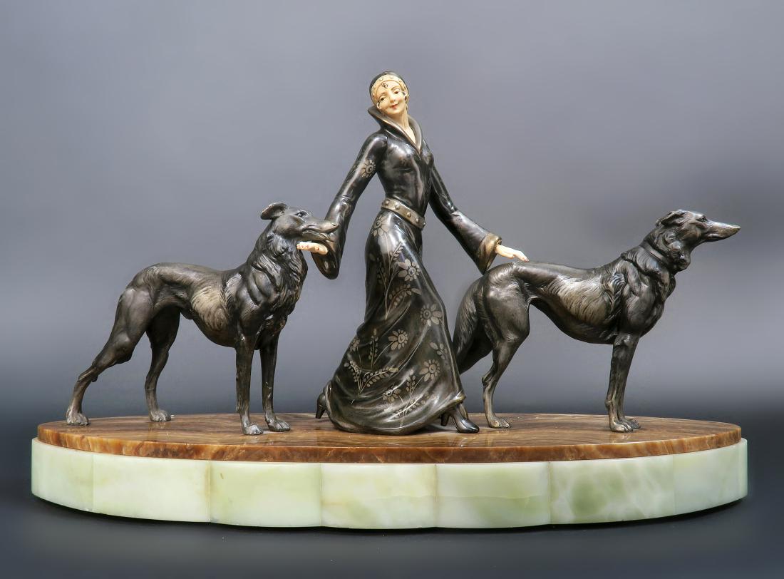 Art Deco After "Demetre Chiparus" Sculpture: Art Deco After "Demetre Chiparus" Sculpture. Cold-painted, parcel-gilt Cast Metal on an onyx base. Circa 1928. 23" x 7" x H 14"