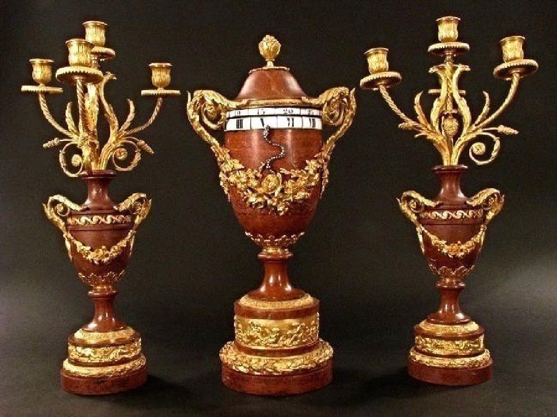 A MAGNIFICENT ROUGE MARBLE AND ORMOLU ROTARY CLOCK SET (1 of 4)