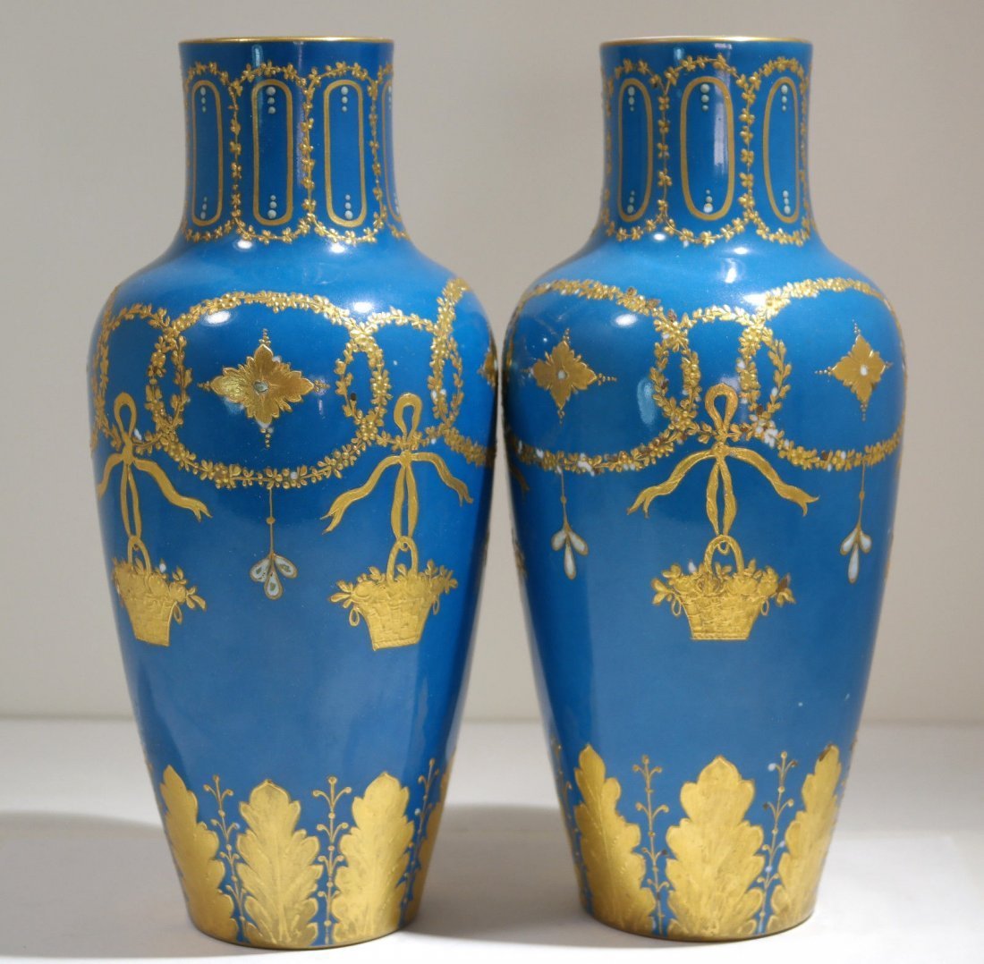 Pair of Turquoise Sevres Porcelain Vases: Sevres pair of hand decorated porcelain vases, painted with gentle gilt floral garlands & wreaths with hanging flower baskets, each center of floral garland painted with diamond form star like ornamen