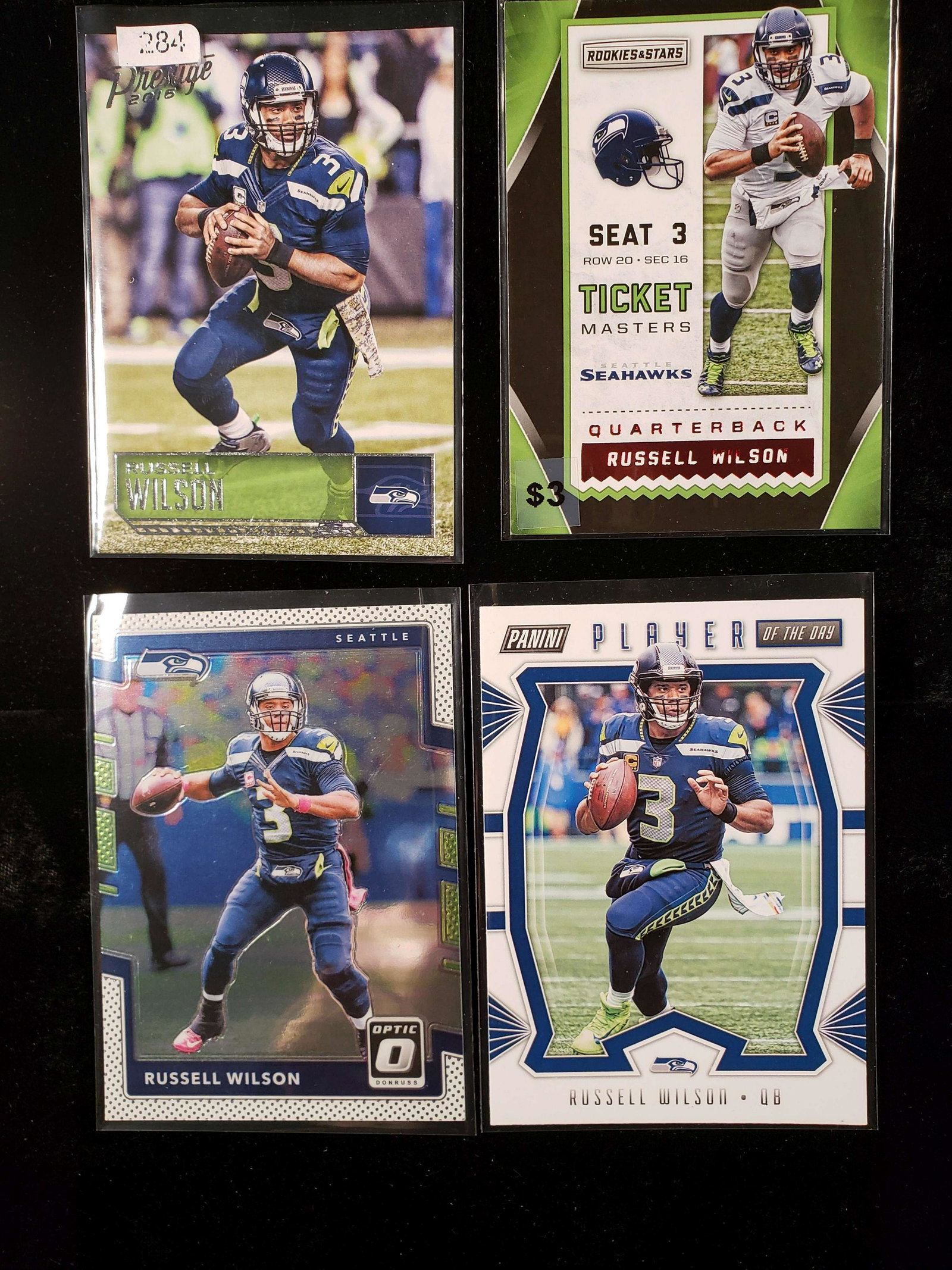 RUSSELL WILSON SEAHAWKS FOOBALL CARD: 4 CARD LOT WITH 1 PANINI PLAYER OF THE DAY