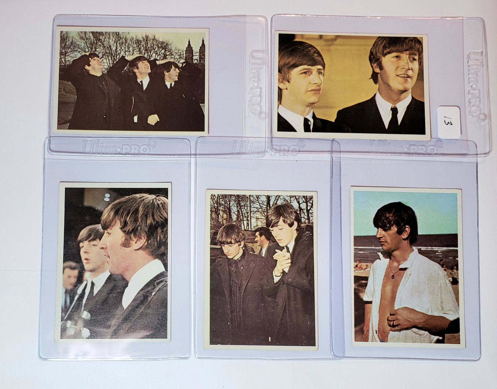 ORIGINAL 1964 BEATLES COLOR SERIES TRADING CARDS: 1964 TOPPS BEATLES COLOR CARDS NICE MID-HIGHER GRADE LOT FEATURING JOHN LENNON, PAUL McCARTNEY, GEORGE HARRISON AND RINGO STARR. THIS LOT IS FROM ORIGINAL OWNER WHO OPENED AND STORED FOR YEARS!