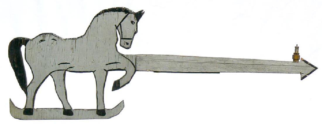 Wooden Folky horse weather vane in old paint: A nice wooden horse weathervane in weathered gray and black paint on both sides. An old spark plug was added to the front of the arrow to make it balance. It is 44 1/2" long by 16" high. The horse is