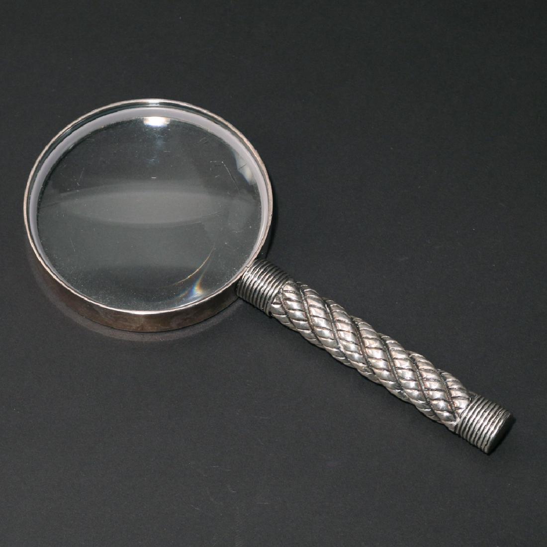 HERMES MAGNIFYING GLASS: weighted silver or silver-plate, with barley-twist handle, marked 'HERMES PARIS MADE IN FRANCE' h. 7-3/4 w. 3-1/2 in.