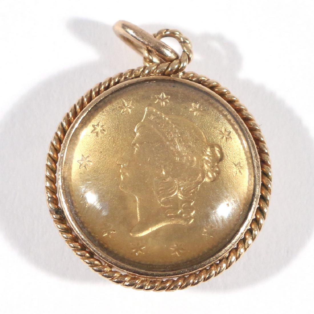 1853 U.S. LIBERTY ONE DOLLAR GOLD COIN: encased as a pendant with gold rope ends and glass sides, total weight appx. 3.9g h. 3/4 in. (over loop)