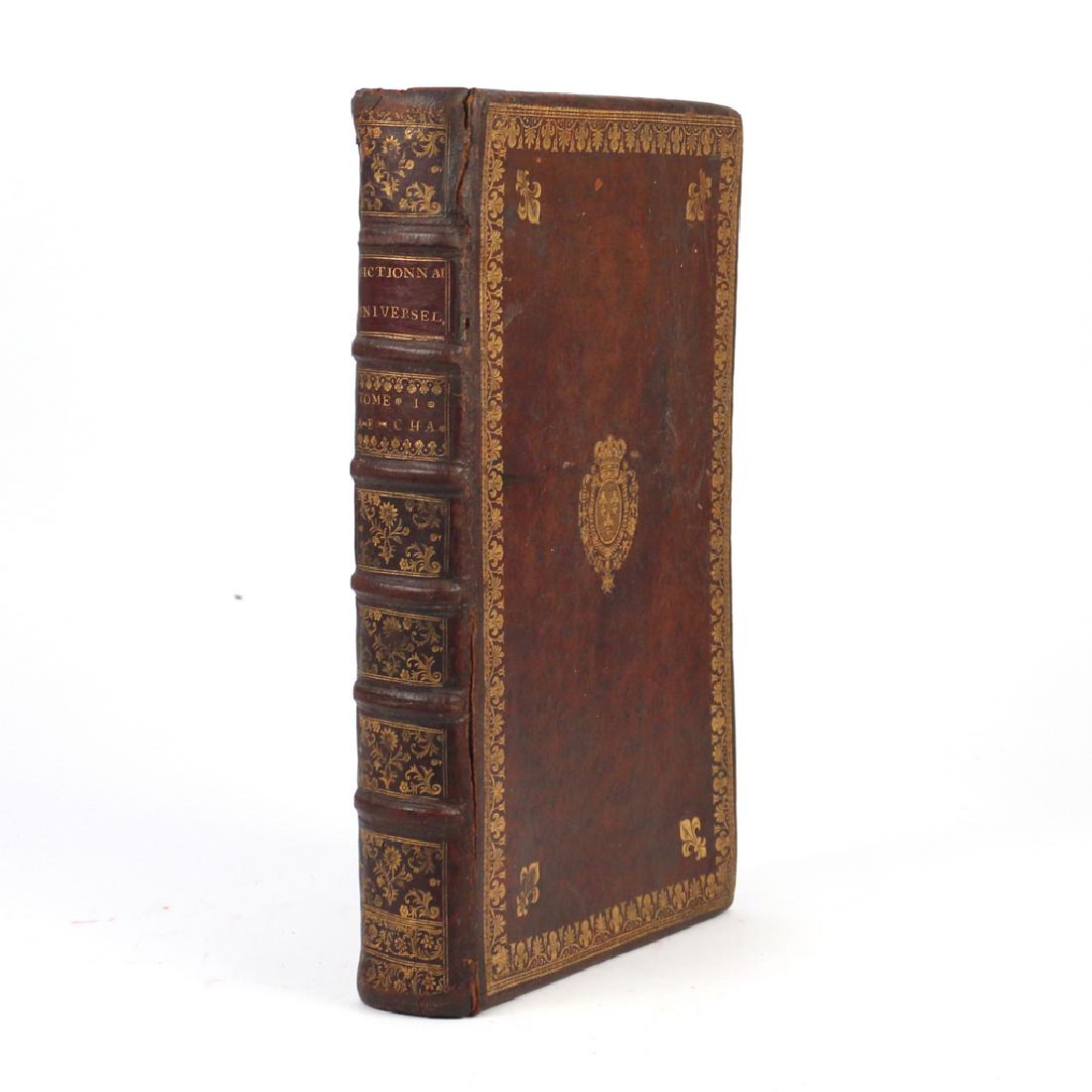 LEATHER BOOK-FORM JEWELRY BOX: 19th Century or earlier, in the form of an early Dictionary, in full leather with tooled front board having coat of arms in center and clover edging h. 16 w. 10-1/4 d. 2-3/4 in.
