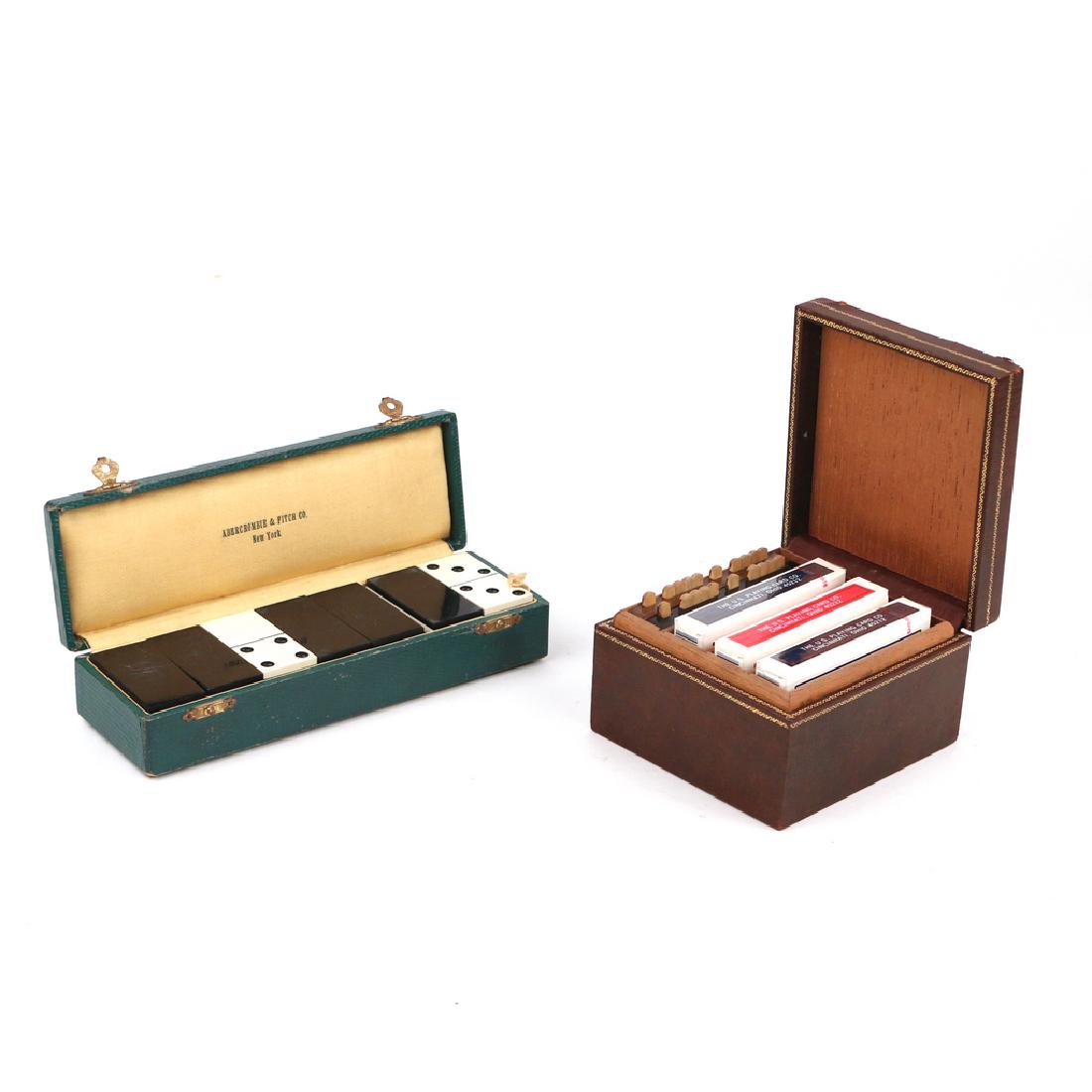 (2pc) ABERCROMBIE & OTHER GAME SETS: including an Ambercrombie & Fitch Co. New York leather dominoes box, early 20th Century, complete with game pieces, 8 in. long; and a tooled leather cedar-lined card box with two Bezique markers, init
