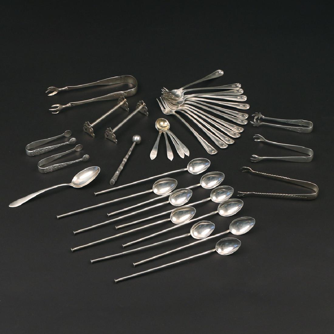 (36pc) MISC. SMALL STERLING FLATWARE: Including 12 Towle condiment forks marked Hank Chang", 10 iced tea stirrer-spoons, 4 gilt bowl salt scoops, 2 knife rests, a teaspoon, 6 various ice tongs and a Tiffany & Co. twig-form muddler; total 