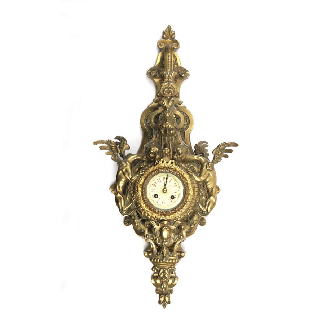 GILT BRONZE CARTEL CLOCK: With griffins flanking a porcelain dial, no apparent marks h. 27 w. 13 in. Provenance: Collection of acknowledged horologist the late Al Mans, formerly Nelsonville, N.Y. Condition: crack in upper left