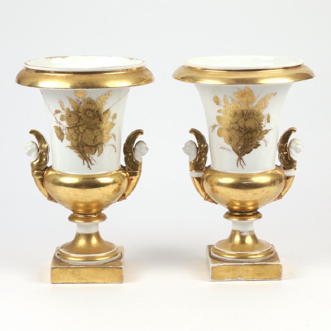 PAIR OF PARIS PORCELAIN URNS: 19th Century, white with gilt overlay h. 11 w. 7-1/4 in. Provenance: The Historic Gerard Crane House, AKA the Stone House, Somers, NY Condition: one with large old repairs