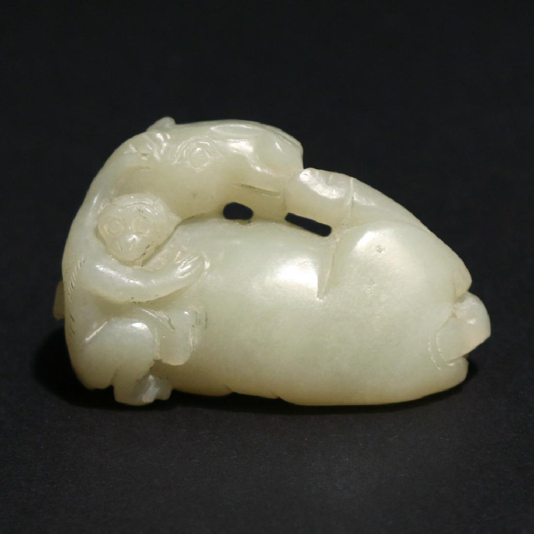 CHINESE NEPHRITE JADE HORSE & MONKEY GROUP: of a pale green color, the recumbent horse itching its nose with his foot and a monkey clinging to his back, specific gravity (2.951) and observed RI calculated by average (1.62) consistent with nephr