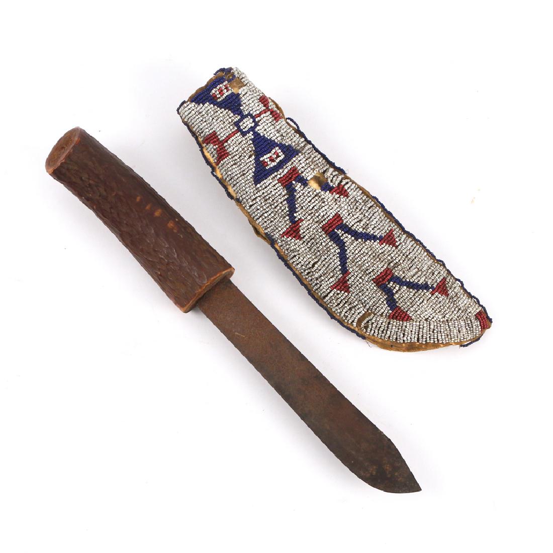 SOUTHWEST AMERICAN INDIAN KNIFE: with stained stag horn handle and beadwork sheath, w/abstract human figures and backed with par fleche knife L. 12 in. Provenance: Huntington, N.Y. estate Condition: sheath with minor damage