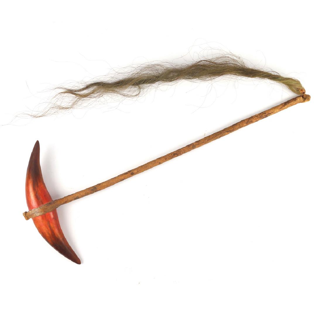 PLAINS INDIAN WAR CLUB: having stained adorsed horn club, handle cov'd w/rawhide ending with hair tassel, L. 24 3/4 in., w. 10 in.