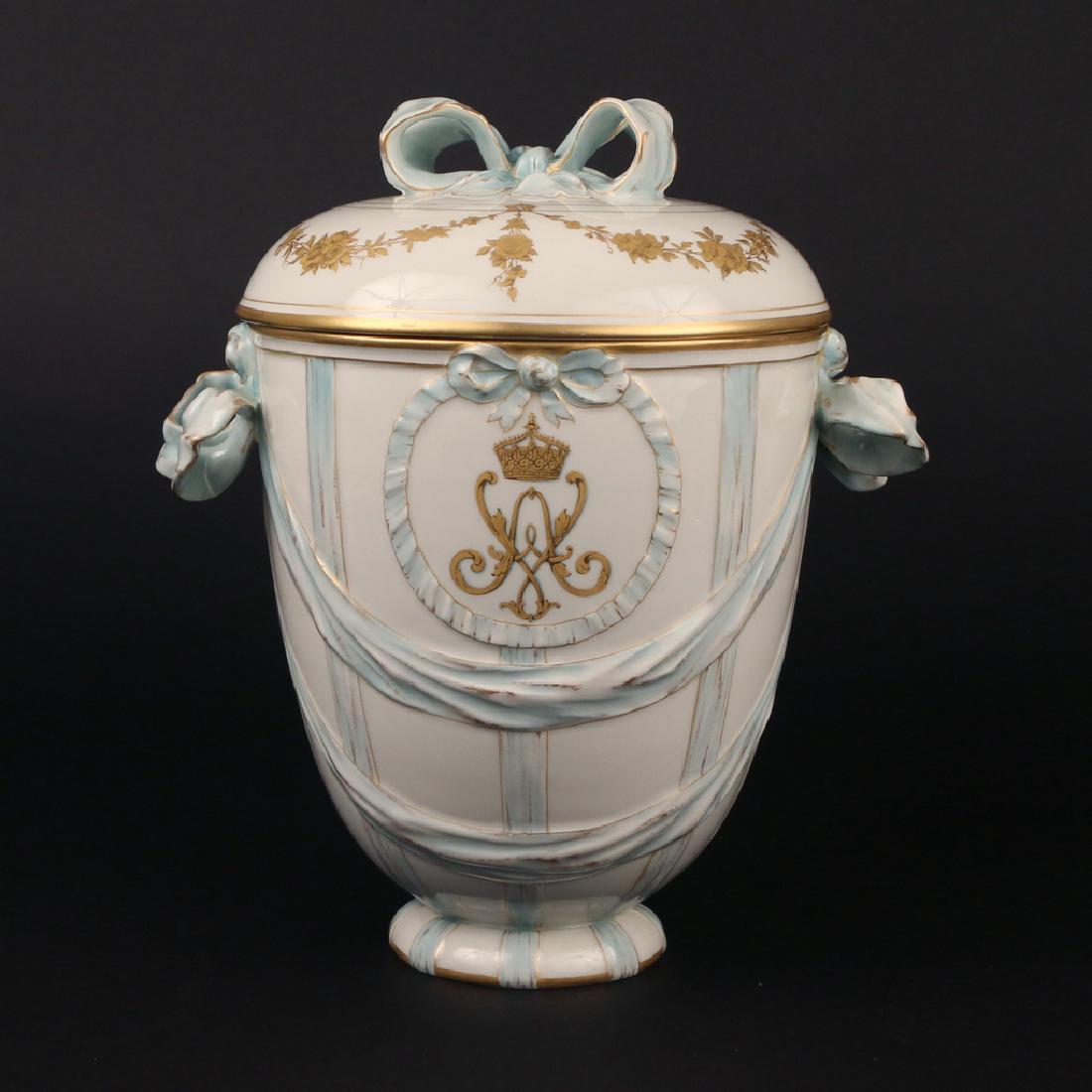 KPM PORCELAIN COVERED JAR: with raised ribbon decoration and gilt conjoined initials under crown within cartouche, marked on base h. 10 1/2 in Condition: no cond. issues noted