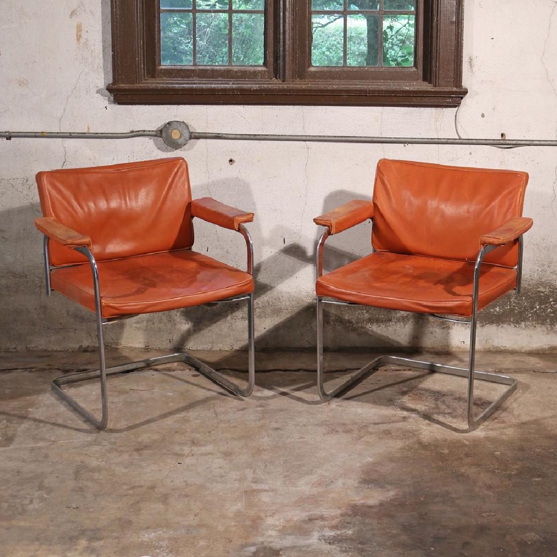 PAIR ROBERT HAUSSMANN / STENDIG ARMCHAIRS: chrome with orange leather seats, having Stendig labels, h. 30 w. 26 d. 23 in.; AUCTION IN SITU ITEM: Please note this is available to view by appointment as it is stored externally to the saleroom Co