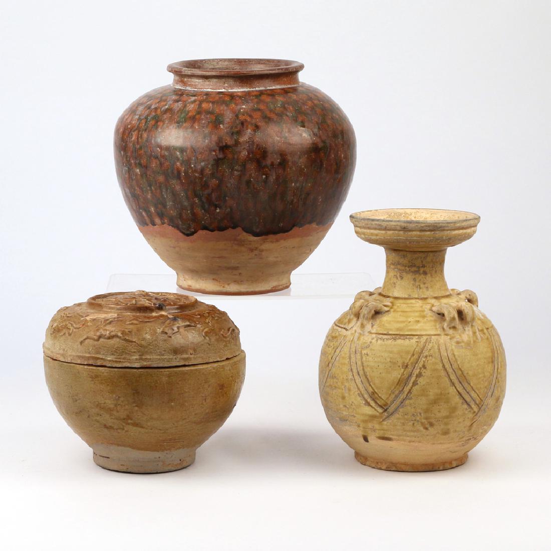 (3pc) ARCHAISTIC CHINESE GLAZED CERAMICS: including a Tang or Tang-style sancai glazed bulbous earthenware jar; a yellow-glazed jar with dish top, double loop handles, and incised pedal design, possibly Tang; and a Han or Han-style round cove