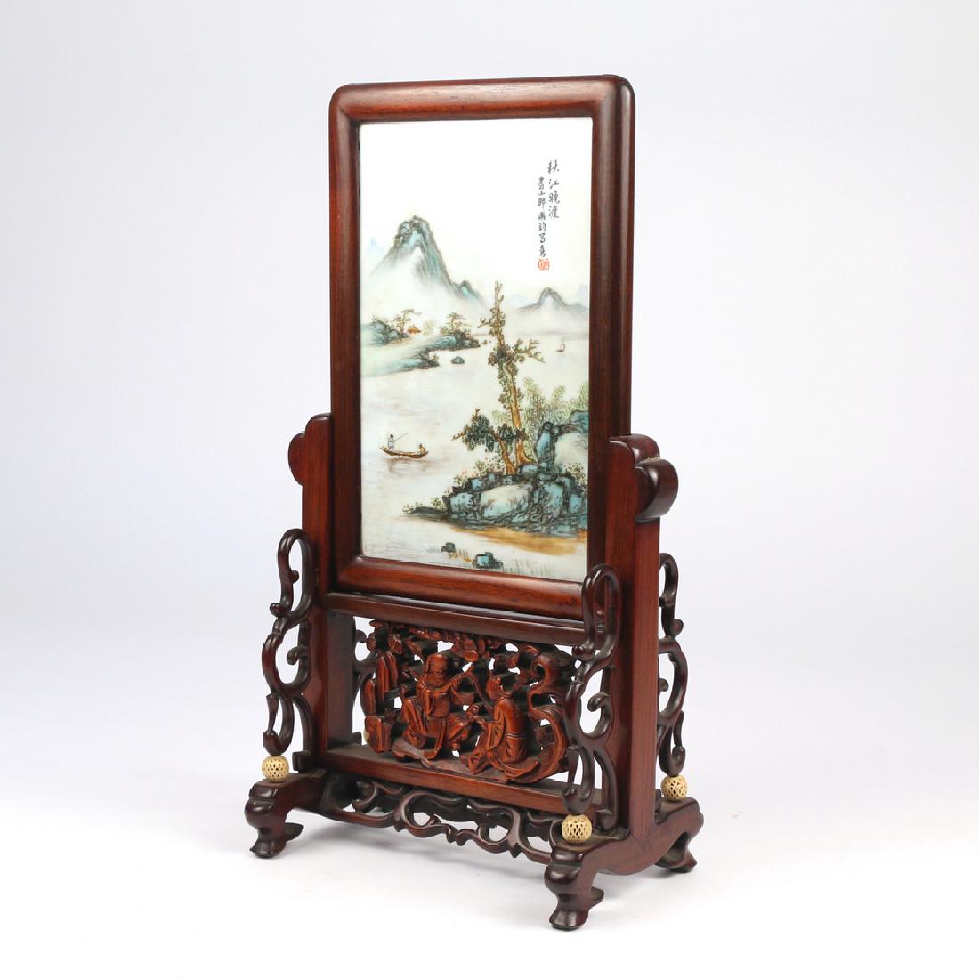 CHINESE PORCELAIN TABLE SCREEN: 20th Century, plaque showing figures fishing in mountainous landscape, stand marked made in China" h. 13 3/4 in. w. 7 1/2 in. d. 4 1/2 in.; 7-5/8 x 4-3/4 in (sight, porcelain) Condition: no cond. issu