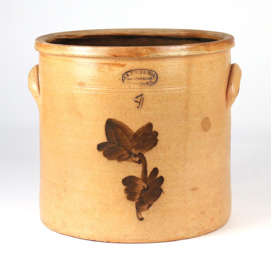 A. E. SMITH & SONS NEW YORK CROCK: a four-gallon cylindrical crock stamped 'A .E. Smith & Sons / Manufacturers / 38 Pook Slip, N. Y.', with floral decoration in brown slip h. 11 w. 13 d. 12 in. Provenance: From the historic Scofield Da