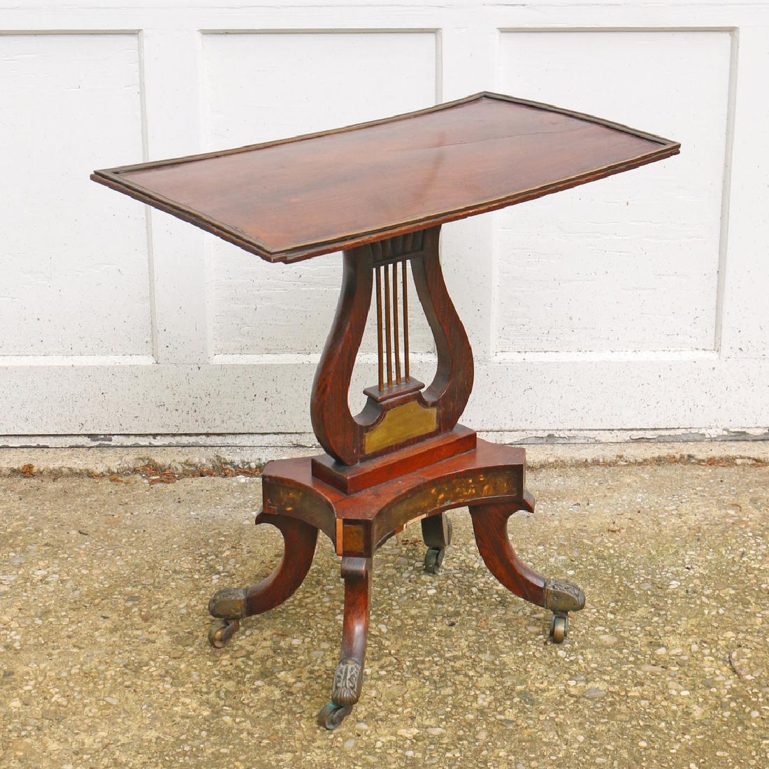 DUNCAN PHYFE LYRE POST ROSEWOOD SIDE TABLE: rectangular top w/metal surround, mounted on lyre, resting on platform, supported by 4-scroll legs w/metal caps on casters h. 22-1/2 w. 21-1/2 d. 13-1/4 in. Provenance: By descent through a New Canaan
